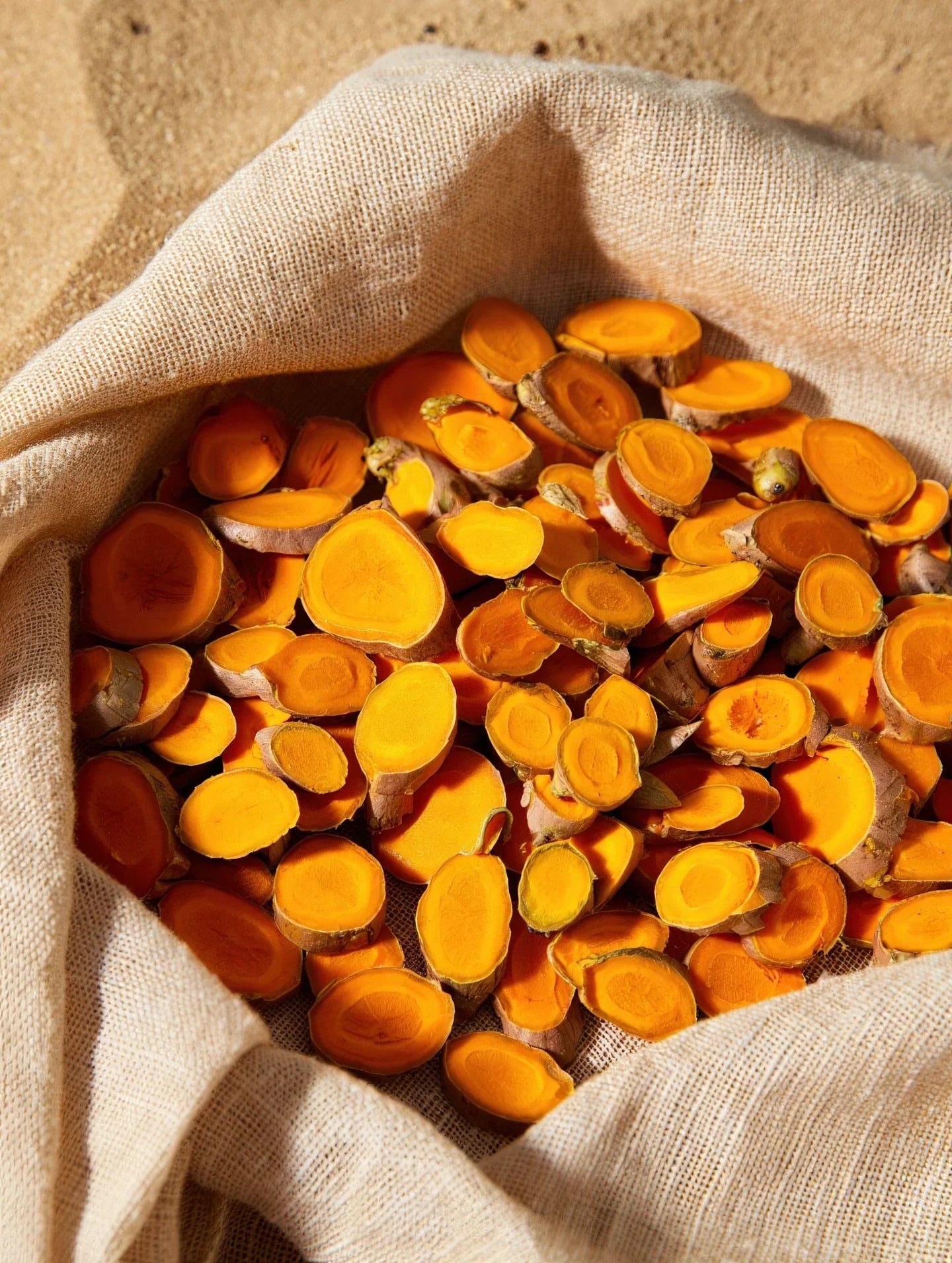 Turmeric powder and roots - natural skin brightening benefits in Multani Mitti clay masks