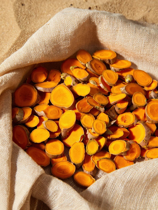 Turmeric powder and roots - natural skin brightening benefits in Multani Mitti clay masks