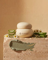 Fulkhari Oasis Sands Clay Mask jar on stone, a purifying Fuller's Earth formula with tea tree oil, chamomile, and aloe vera.