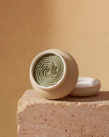 Open jar showing the creamy, cooling texture of the sage green Multani Mitti clay mask for acne-prone skin.